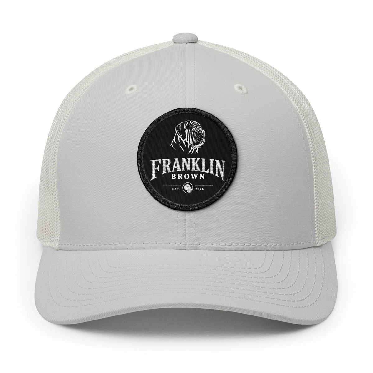 White mesh trucker cap with a small round top button and a circular logo patch featuring a dog and the text Franklin Brown, SKU: 18313259272057124290
