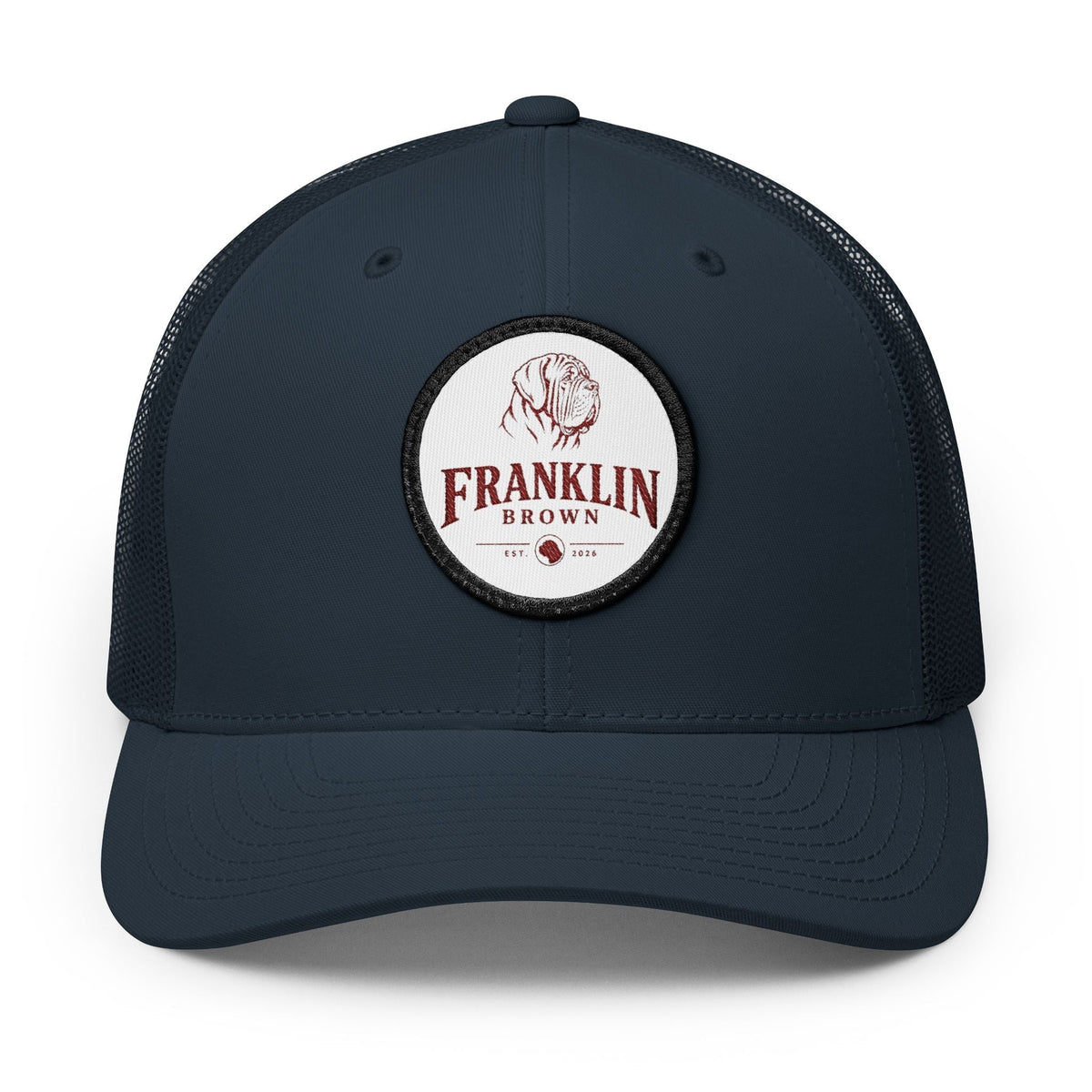 Navy blue mesh trucker cap with adjustable snapback closure and a circular logo patch featuring a dog illustration and 'Franklin Brown' text