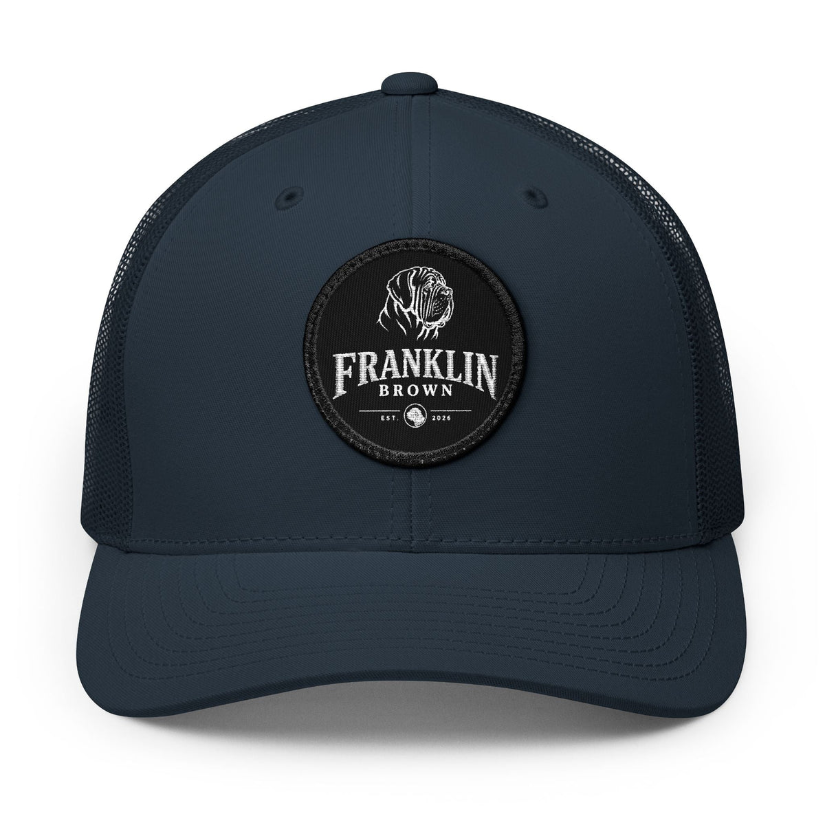 Dark navy mesh trucker cap with a round top button and adjustable snapback closure, featuring a black circular patch with a dog logo and 'Franklin Brown' text