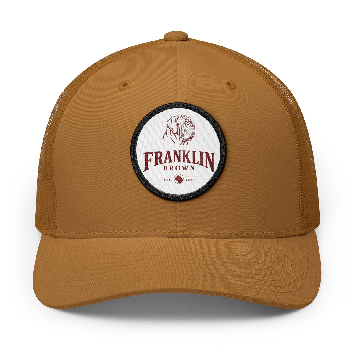 Brown mesh trucker cap with adjustable snapback closure, featuring a circular logo patch with a dog illustration and 'Franklin Brown' text